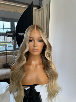 Model wearing blonde balayage 24-inch HD lace human hair wig in body wave texture – Nuola Wigs.