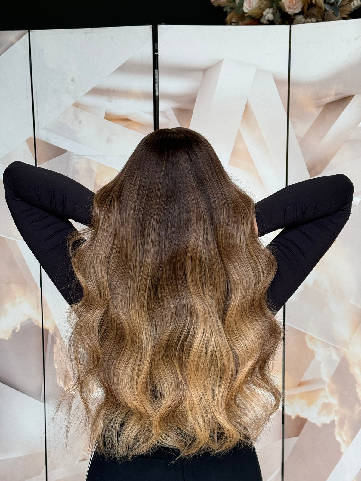 Model wearing blonde balayage 24-inch HD lace human hair wig in body wave texture – Nuola Wigs.