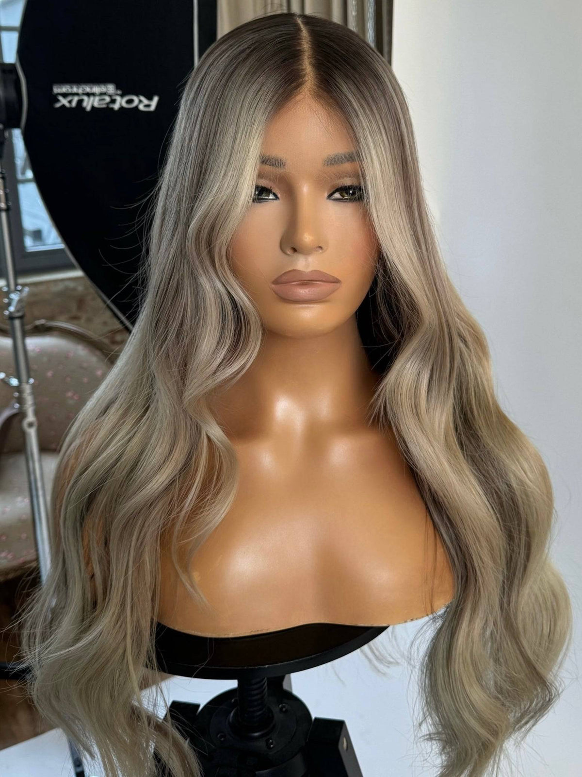 Model wearing blonde balayage 24-inch HD lace human hair wig in body wave texture – Nuola Wigs.