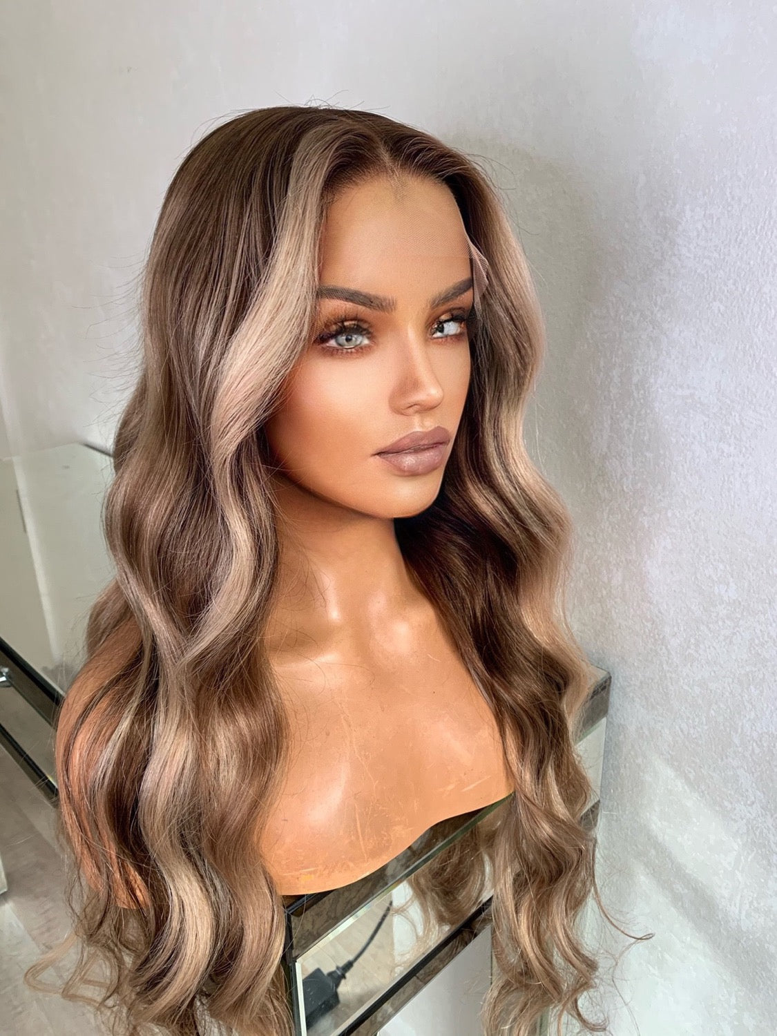 Model wearing blonde balayage 26-inch HD lace human hair wig in body wave texture – Nuola Wigs.