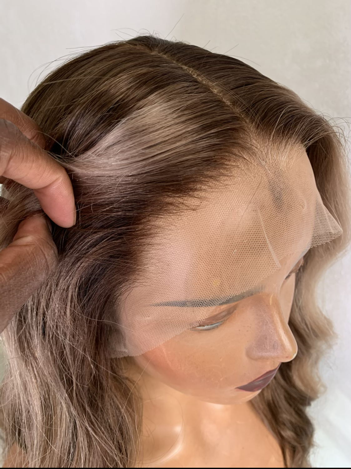 Model wearing blonde balayage 26-inch HD lace human hair wig in body wave texture – Nuola Wigs.