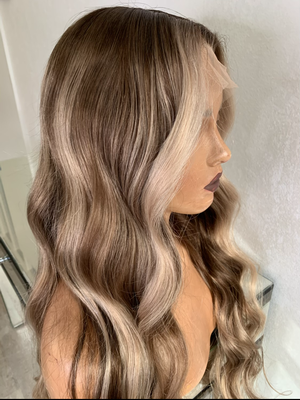 Model wearing blonde balayage 26-inch HD lace human hair wig in body wave texture – Nuola Wigs.