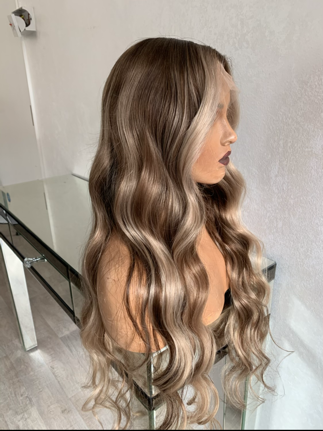 Model wearing blonde balayage 26-inch HD lace human hair wig in body wave texture – Nuola Wigs.