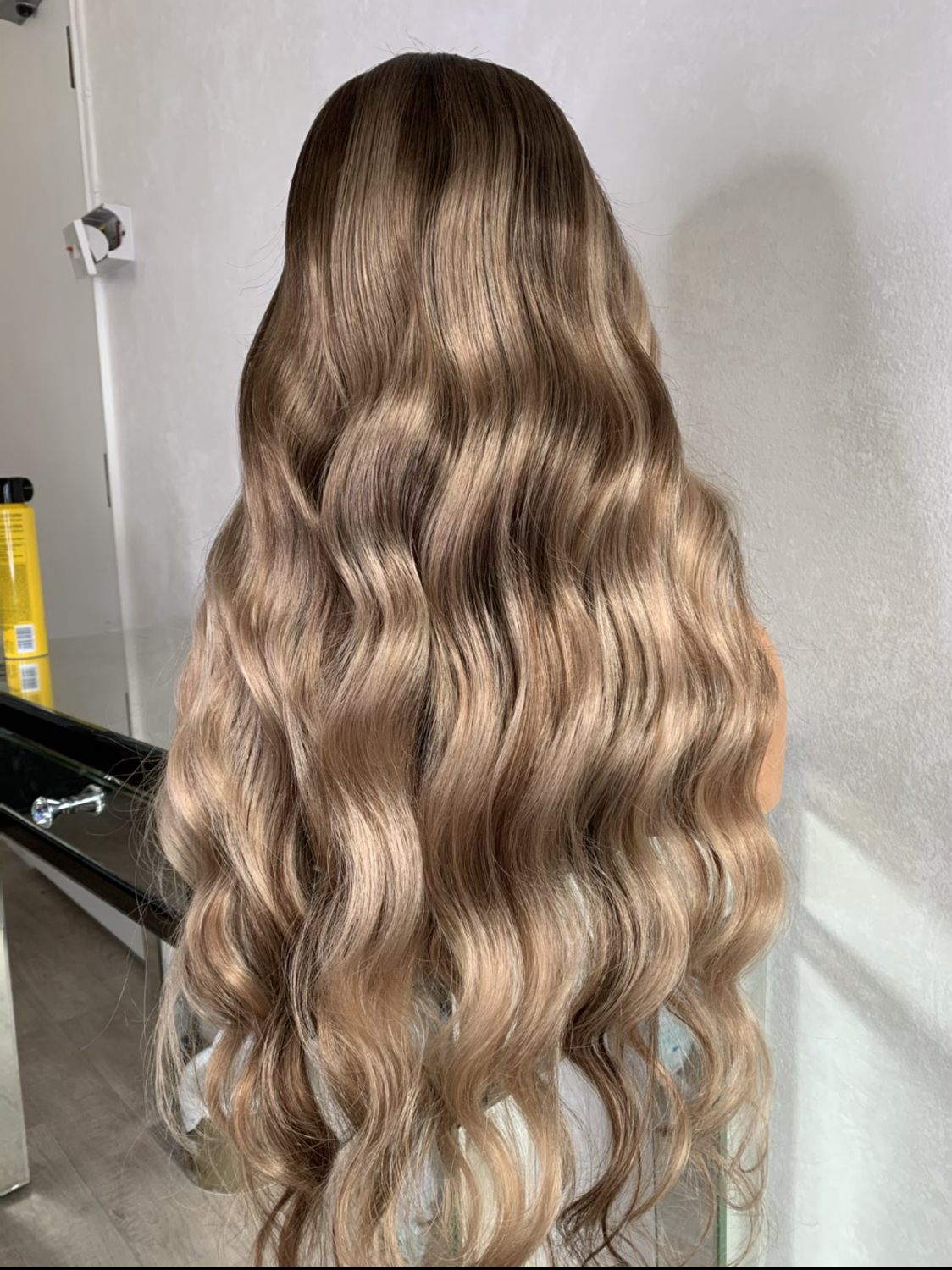 Model wearing blonde balayage 26-inch HD lace human hair wig in body wave texture – Nuola Wigs.