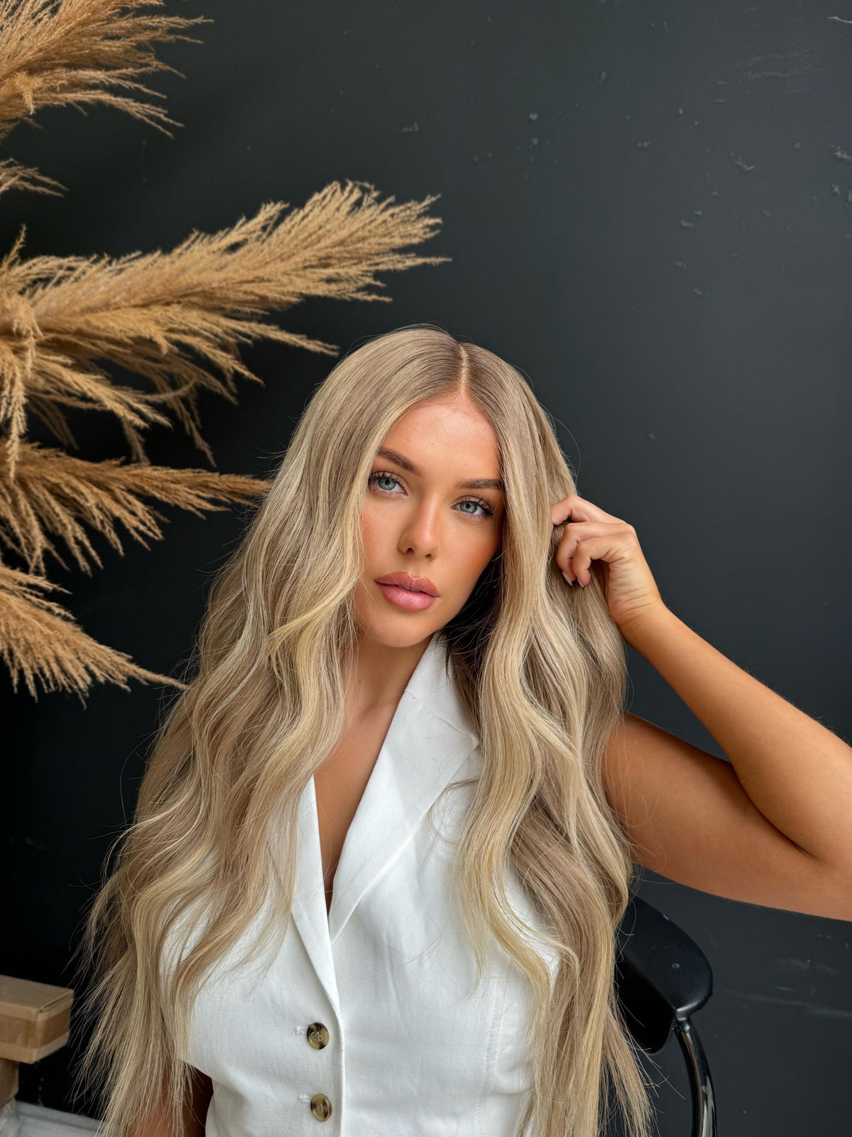 Model wearing blonde balayage 26-inch HD lace human hair wig in body wave texture – Nuola Wigs.