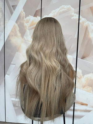 Model wearing blonde balayage 26-inch HD lace human hair wig in body wave texture – Nuola Wigs.