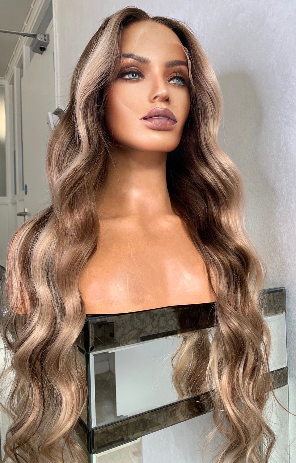 Model wearing blonde balayage 26-inch HD lace human hair wig in body wave texture – Nuola Wigs.