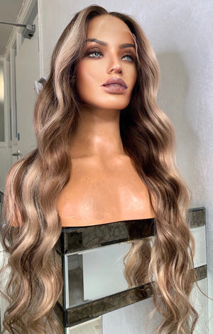 Model wearing blonde balayage 26-inch HD lace human hair wig in body wave texture – Nuola Wigs.