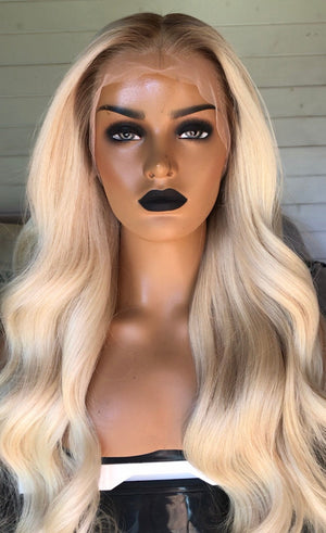 Model wearing blonde balayage 28-inch HD lace human hair wig in body wave texture – Nuola Wigs.