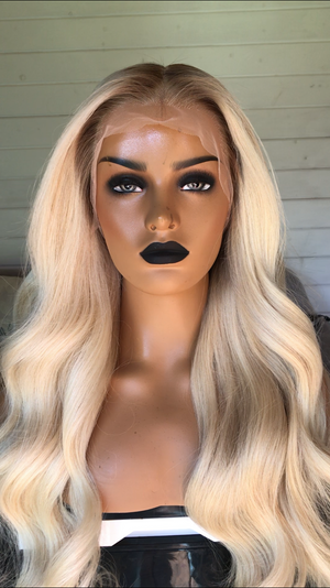 Model wearing blonde balayage 28-inch HD lace human hair wig in body wave texture – Nuola Wigs.
