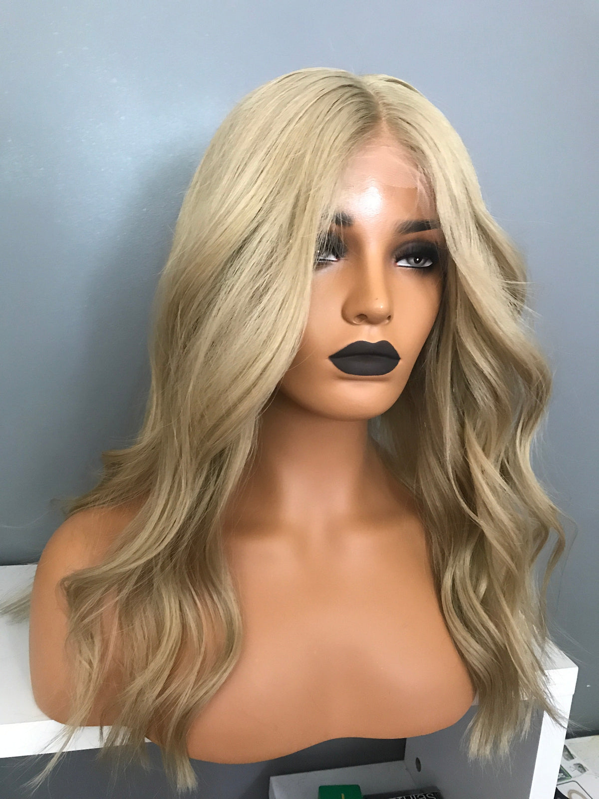 Model wearing brown balayage 18-inch HD lace human hair wig in body wave texture – Nuola Wigs.