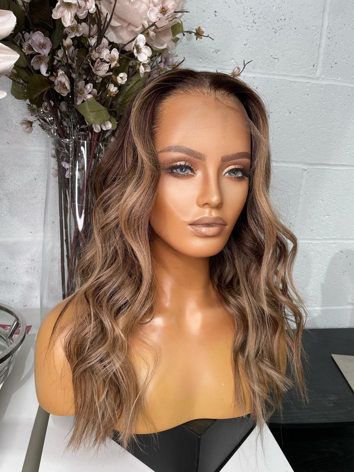 Model wearing brown balayage 20-inch HD lace human hair wig in body wave texture – Nuola Wigs.
