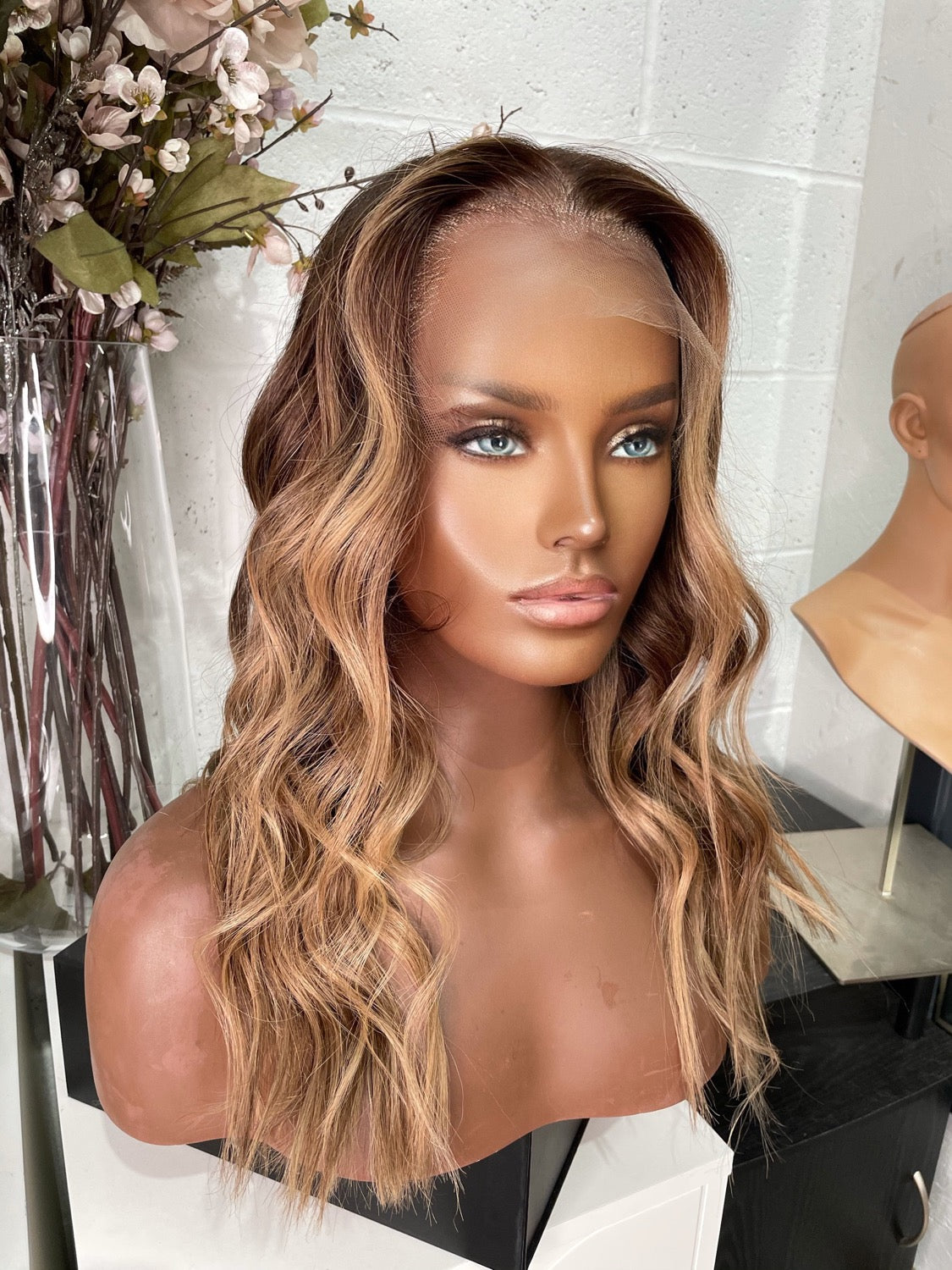 Model wearing brown balayage 20-inch HD lace human hair wig in body wave texture – Nuola Wigs.