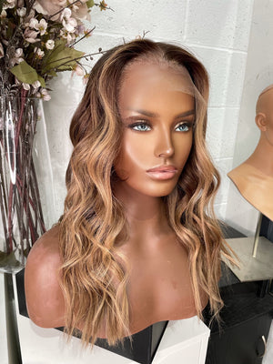 Model wearing brown balayage 20-inch HD lace human hair wig in body wave texture – Nuola Wigs.