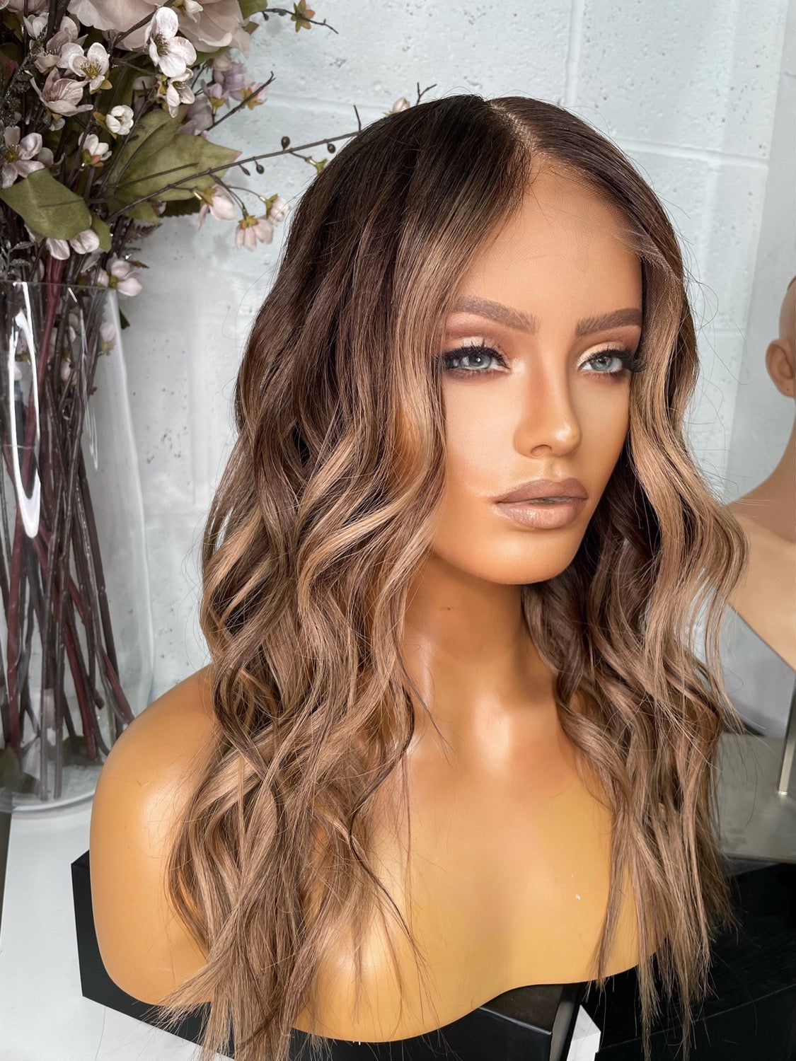 Model wearing brown balayage 20-inch HD lace human hair wig in body wave texture – Nuola Wigs.