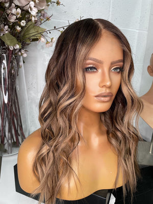 Model wearing brown balayage 20-inch HD lace human hair wig in body wave texture – Nuola Wigs.