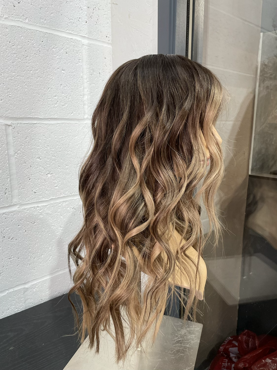 Model wearing brown balayage 20-inch HD lace human hair wig in body wave texture – Nuola Wigs.