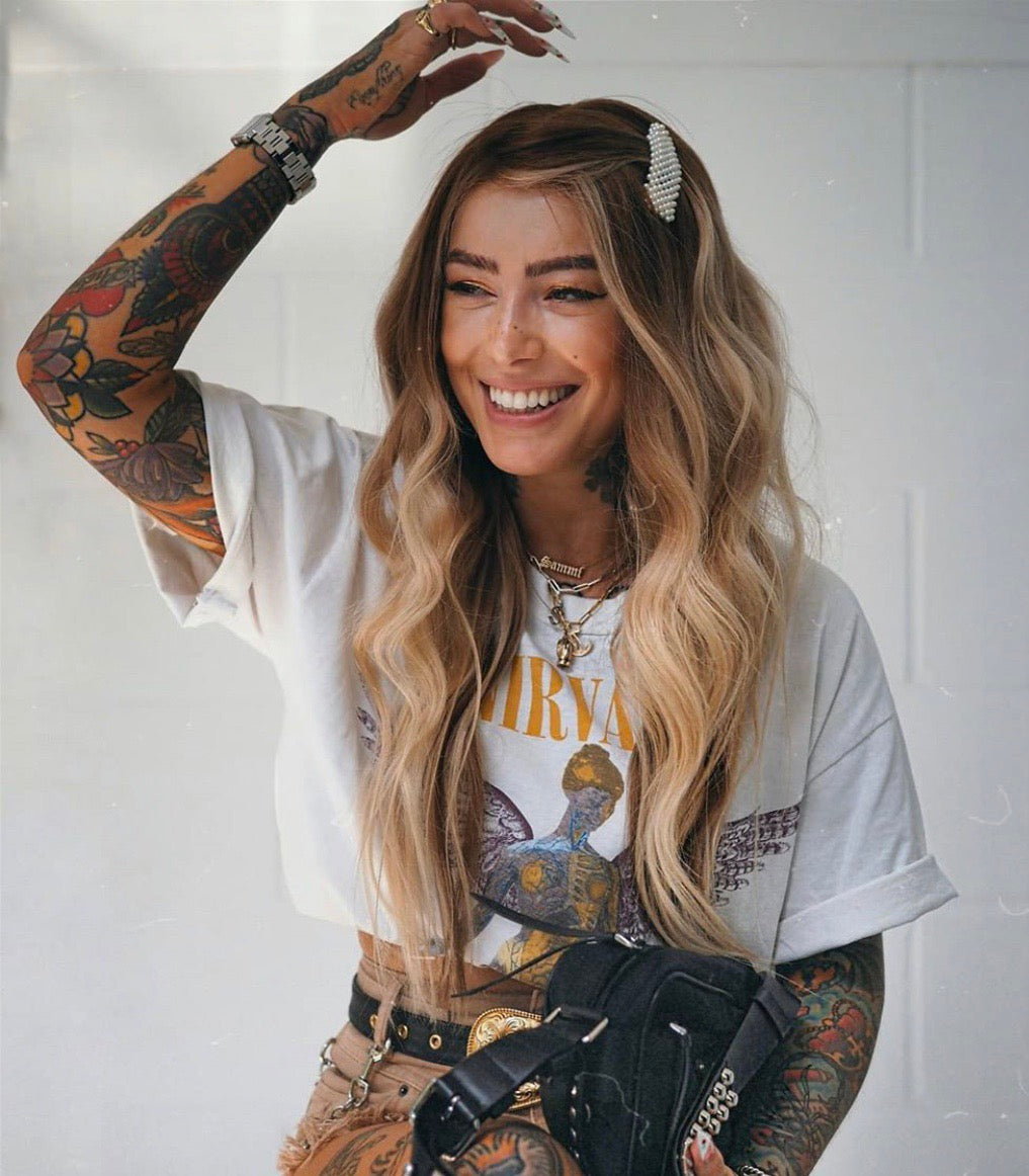 Model wearing brown balayage 20-inch HD lace human hair wig in body wave texture – Nuola Wigs.