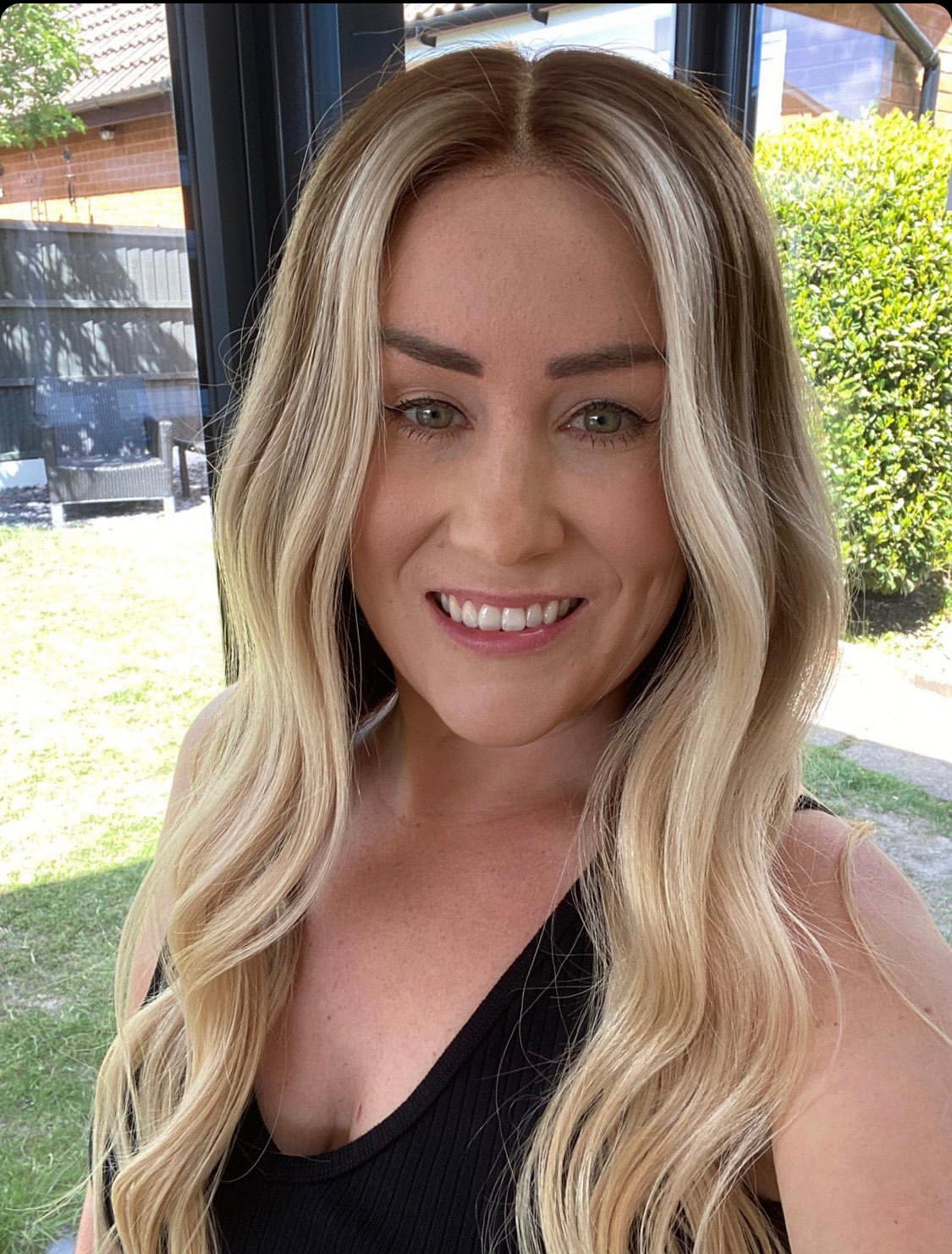 Model wearing brown balayage 20-inch HD lace human hair wig in body wave texture – Nuola Wigs.