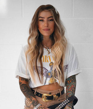 Model wearing brown balayage 20-inch HD lace human hair wig in body wave texture – Nuola Wigs.