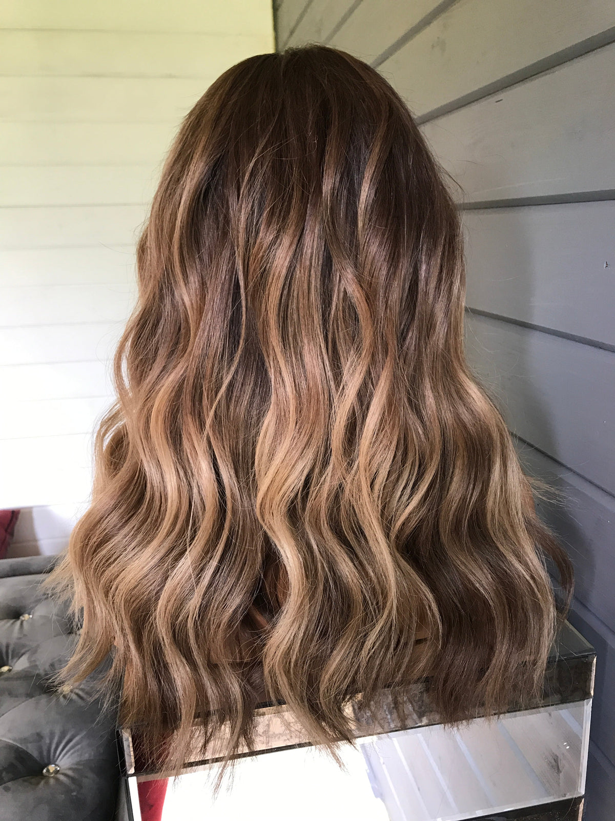 Model wearing brown balayage 22-inch HD lace human hair wig in body wave texture – Nuola Wigs.