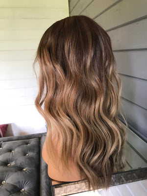 Model wearing brown balayage 22-inch HD lace human hair wig in body wave texture – Nuola Wigs.