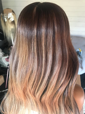 Model wearing brown balayage 22-inch HD lace human hair wig in body wave texture – Nuola Wigs.