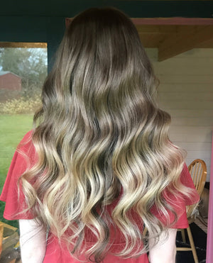 Model wearing brown balayage 22-inch HD lace human hair wig in body wave texture – Nuola Wigs.