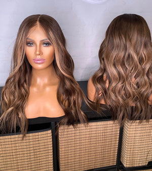 Model wearing brown balayage 22-inch HD lace human hair wig in body wave texture – Nuola Wigs.