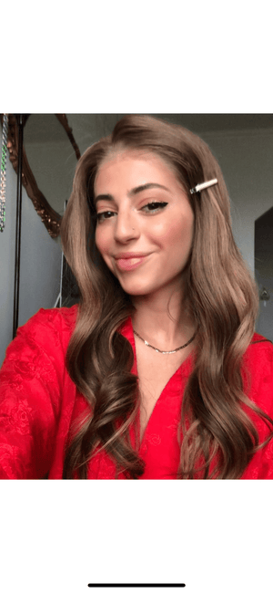 Model wearing brown balayage 22-inch HD lace human hair wig in body wave texture – Nuola Wigs.