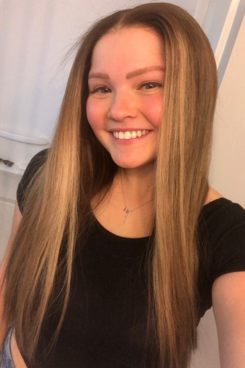 Model wearing brown balayage 22-inch HD lace human hair wig in body wave texture – Nuola Wigs.