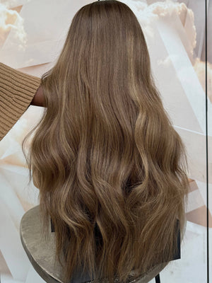 Model wearing brown balayage 24-inch HD lace human hair wig in body wave texture – Nuola Wigs.