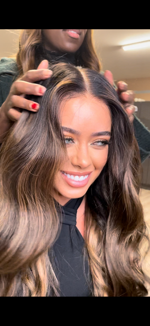 Model wearing brown balayage 24-inch HD lace human hair wig in body wave texture – Nuola Wigs.