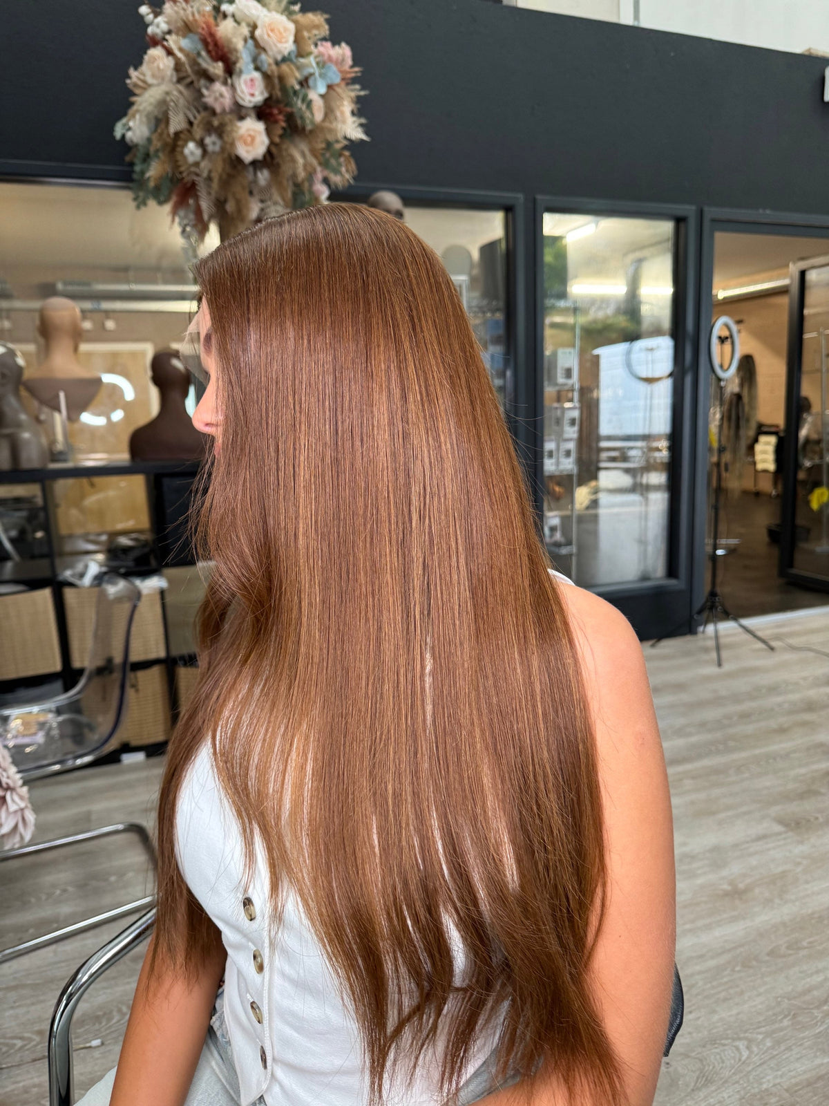 Model wearing brown balayage 24-inch HD lace human hair wig in body wave texture – Nuola Wigs.