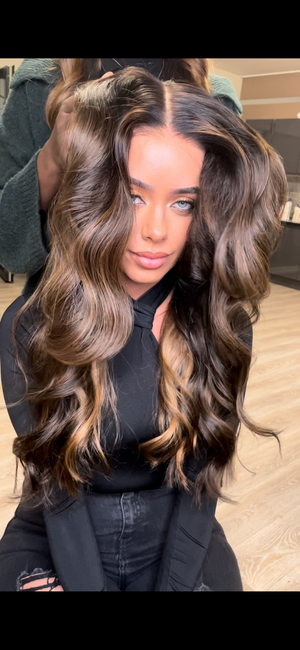 Model wearing brown balayage 24-inch HD lace human hair wig in body wave texture – Nuola Wigs.
