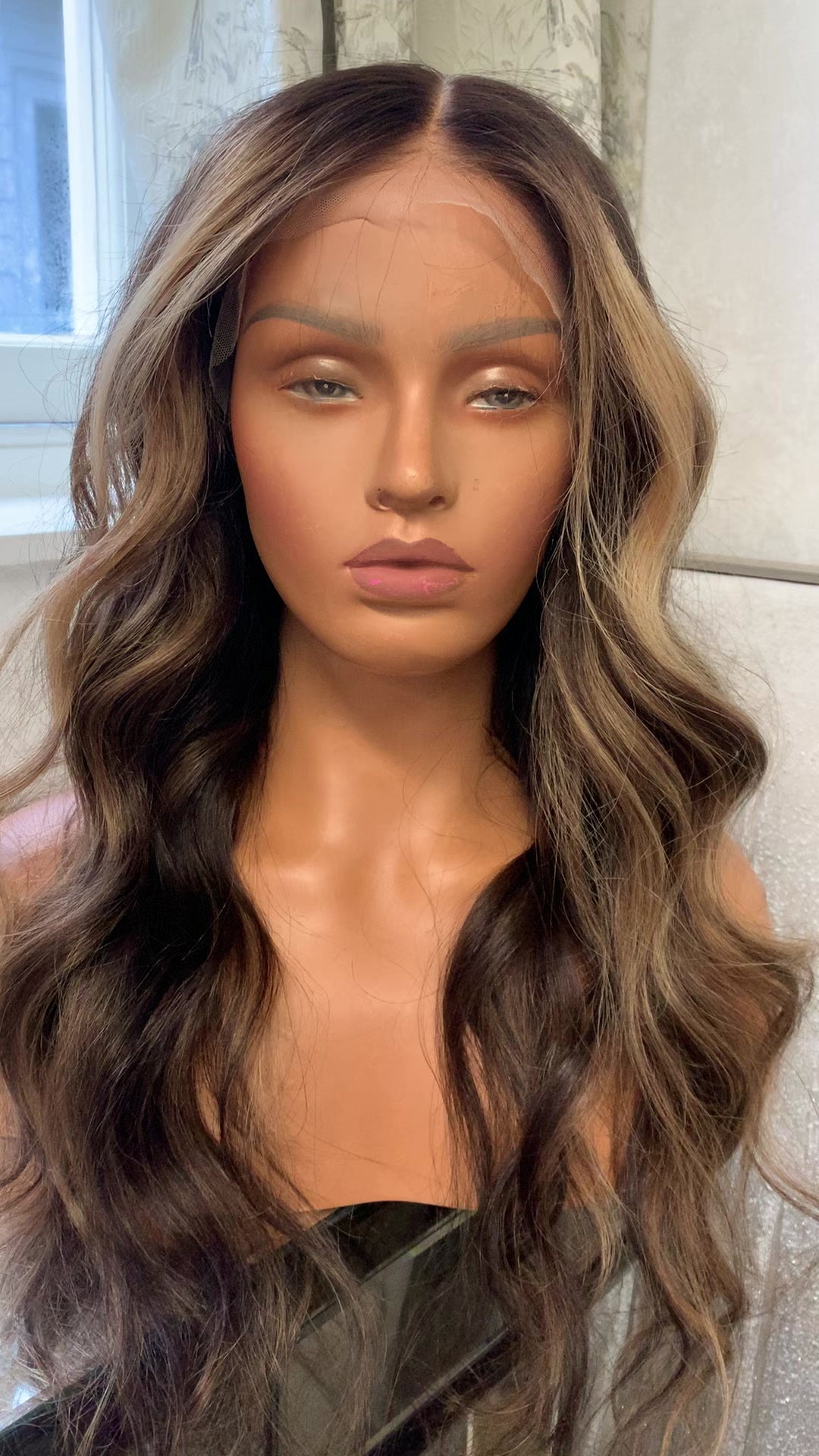Model wearing brown balayage 24-inch HD lace human hair wig in body wave texture – Nuola Wigs.