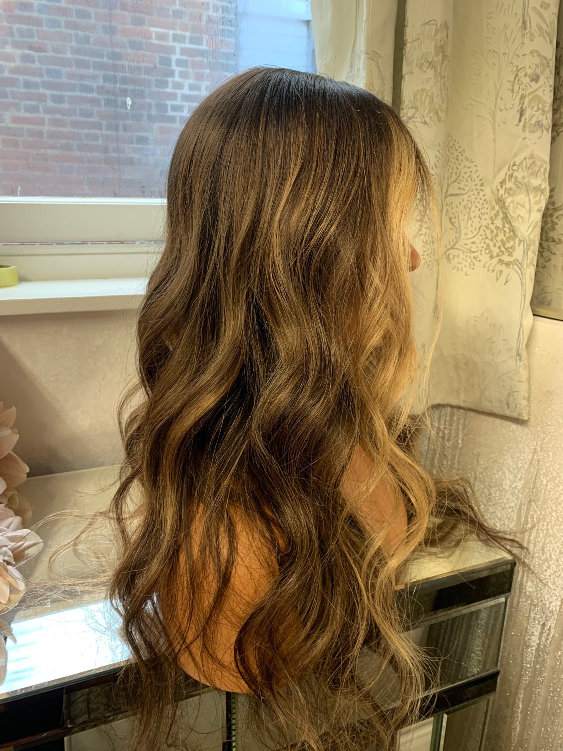 Model wearing brown balayage 24-inch HD lace human hair wig in body wave texture – Nuola Wigs.