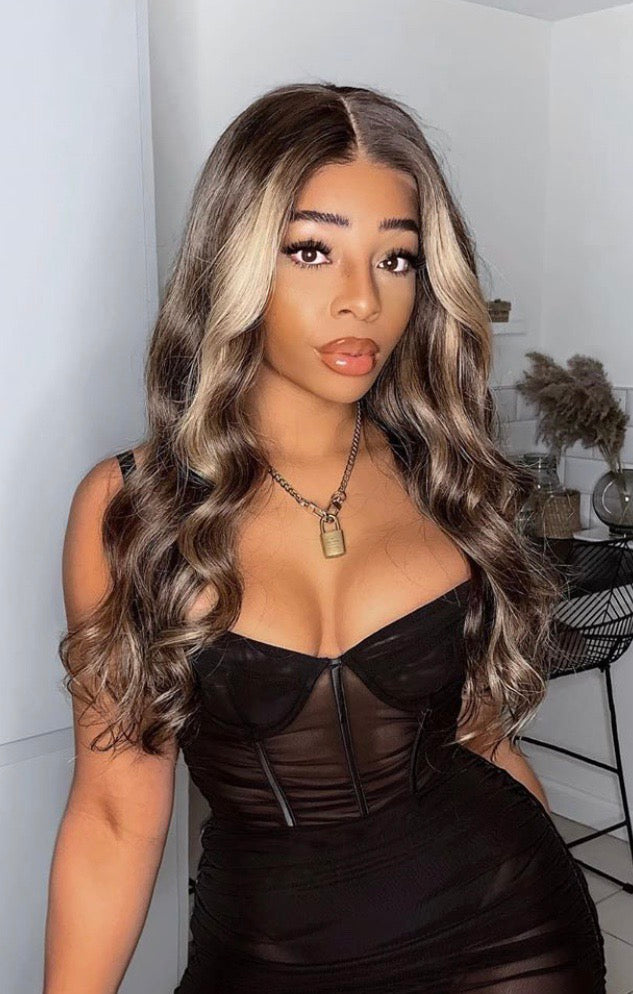 Model wearing brown balayage 24-inch HD lace human hair wig in body wave texture – Nuola Wigs.