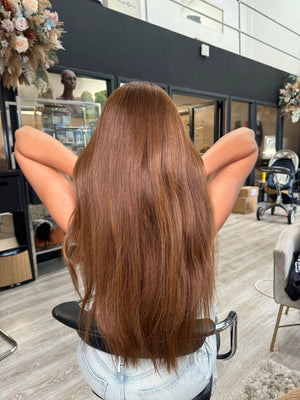 Model wearing brown balayage 24-inch HD lace human hair wig in body wave texture – Nuola Wigs.