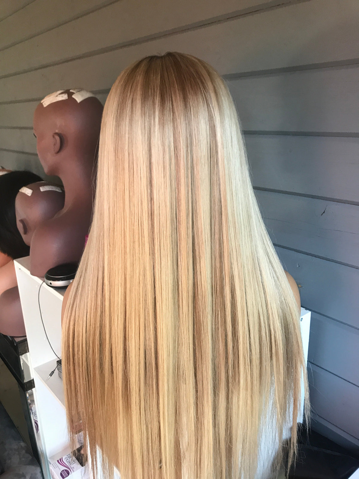 Model wearing brown balayage 24-inch HD lace human hair wig in body wave texture – Nuola Wigs.