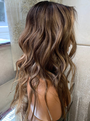 Model wearing brown balayage 18-inch HD lace human hair wig in body wave texture – Nuola Wigs.