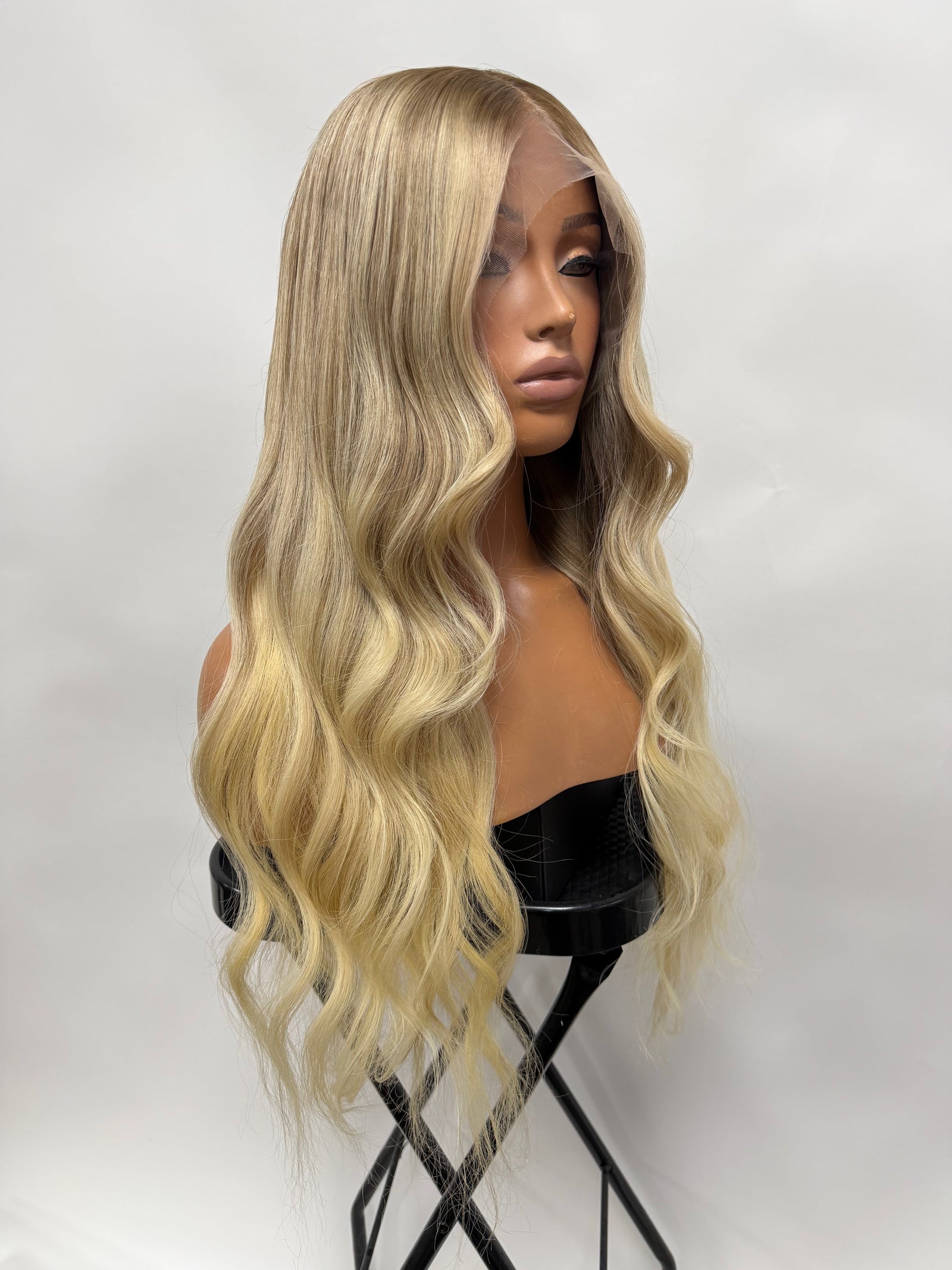 Model wearing blonde balayage 20-inch HD lace human hair wig in body wave texture – Nuola Wigs.