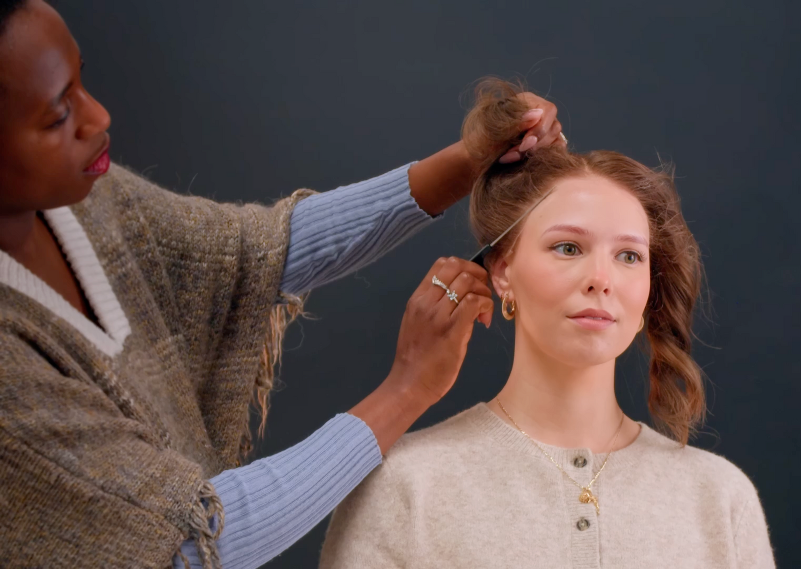 Customer trying on a human hair wig with expert guidance at Oakville wig boutique